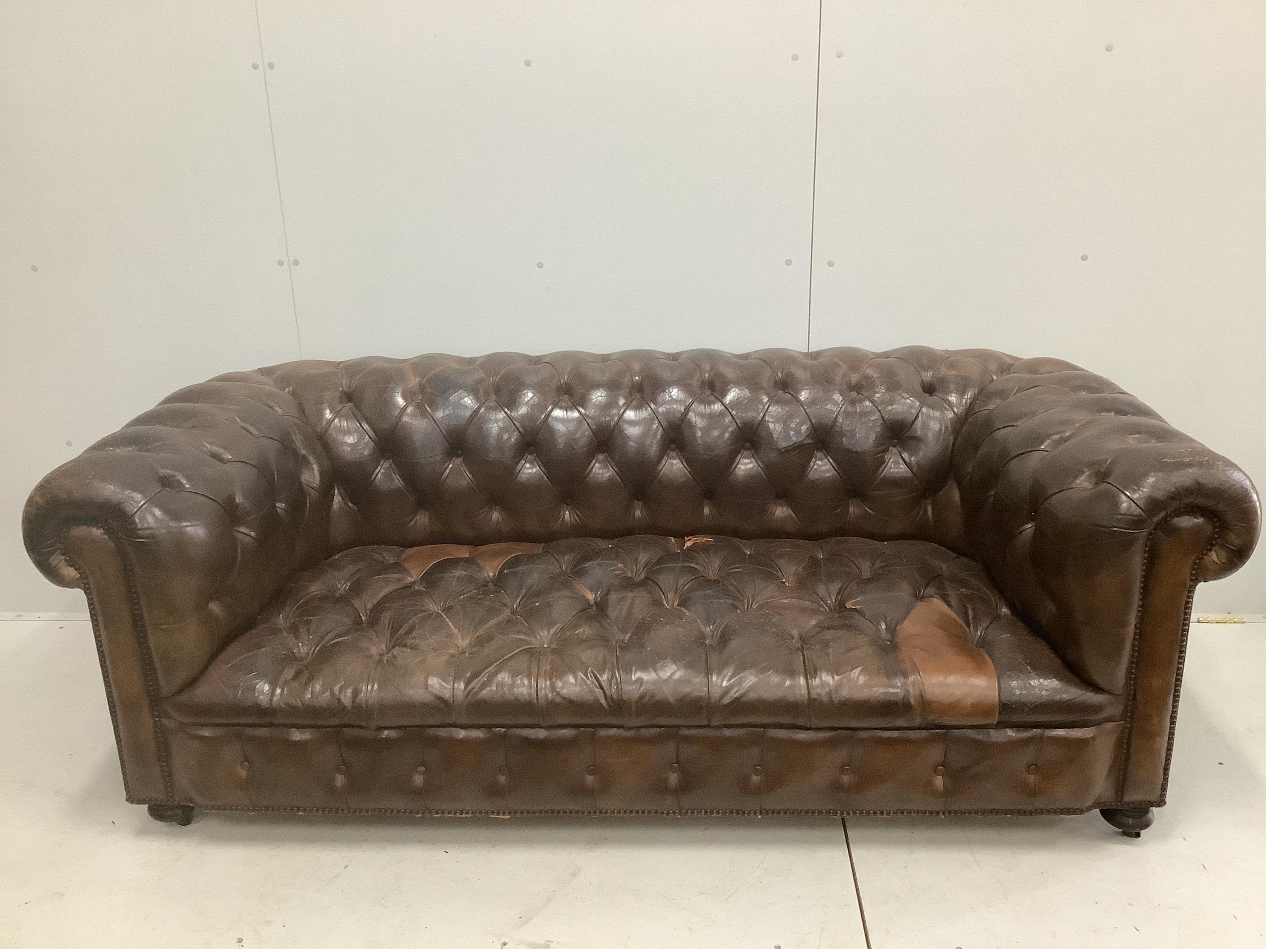 An early 20th century buttoned brown leather Chesterfield sofa, width 200cm, depth 90cm, height 72cm. Condition - fair, some patching and minor tears